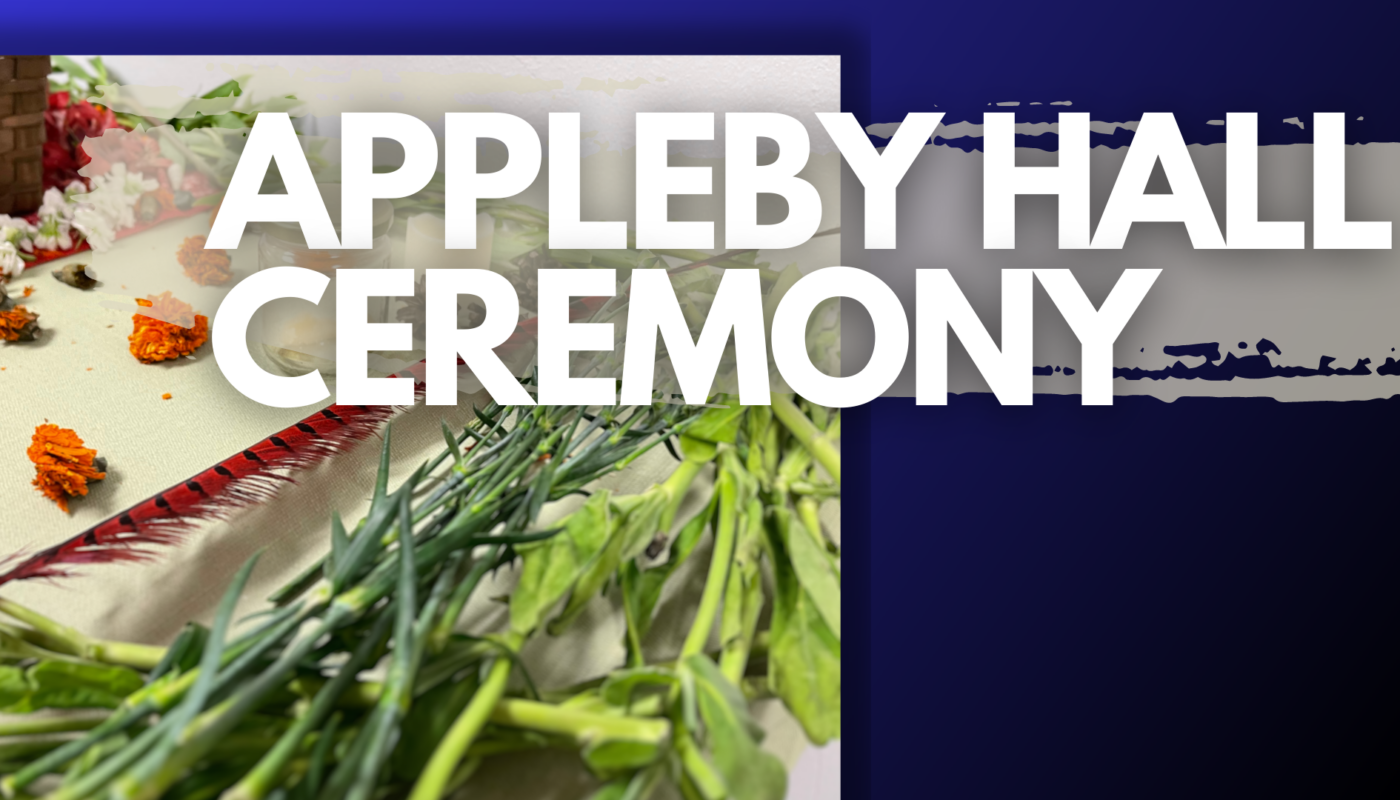 Picture of alter with flowers and greenery. With text titling appleby hall ceremony over a blue background.