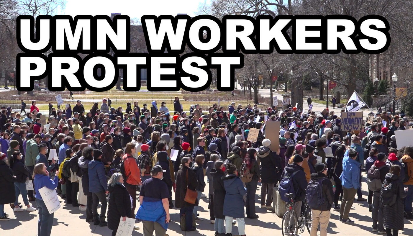 A demonstration at the University of Minnesota shows a diverse crowd of people gathered in solidarity. Many hold handmade signs, and some wear hats and backpacks. Overhead, large bold text states "UMN WORKERS PROTEST."