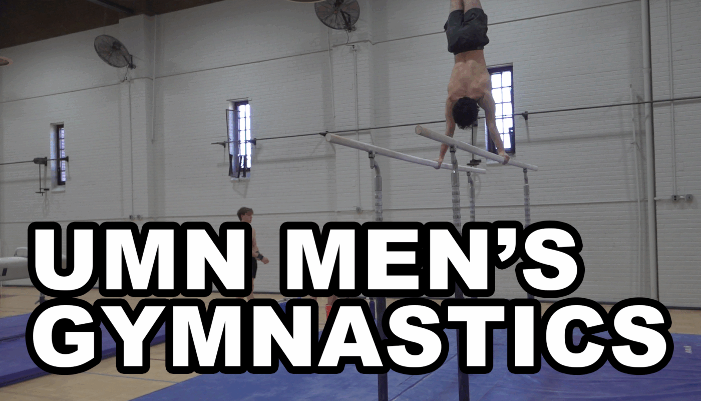 A male gymnast performs a handstand on parallel bars in a gymnasium with high ceilings, while bold white text with a black outline reads “UMN Men’s Gymnastics.”