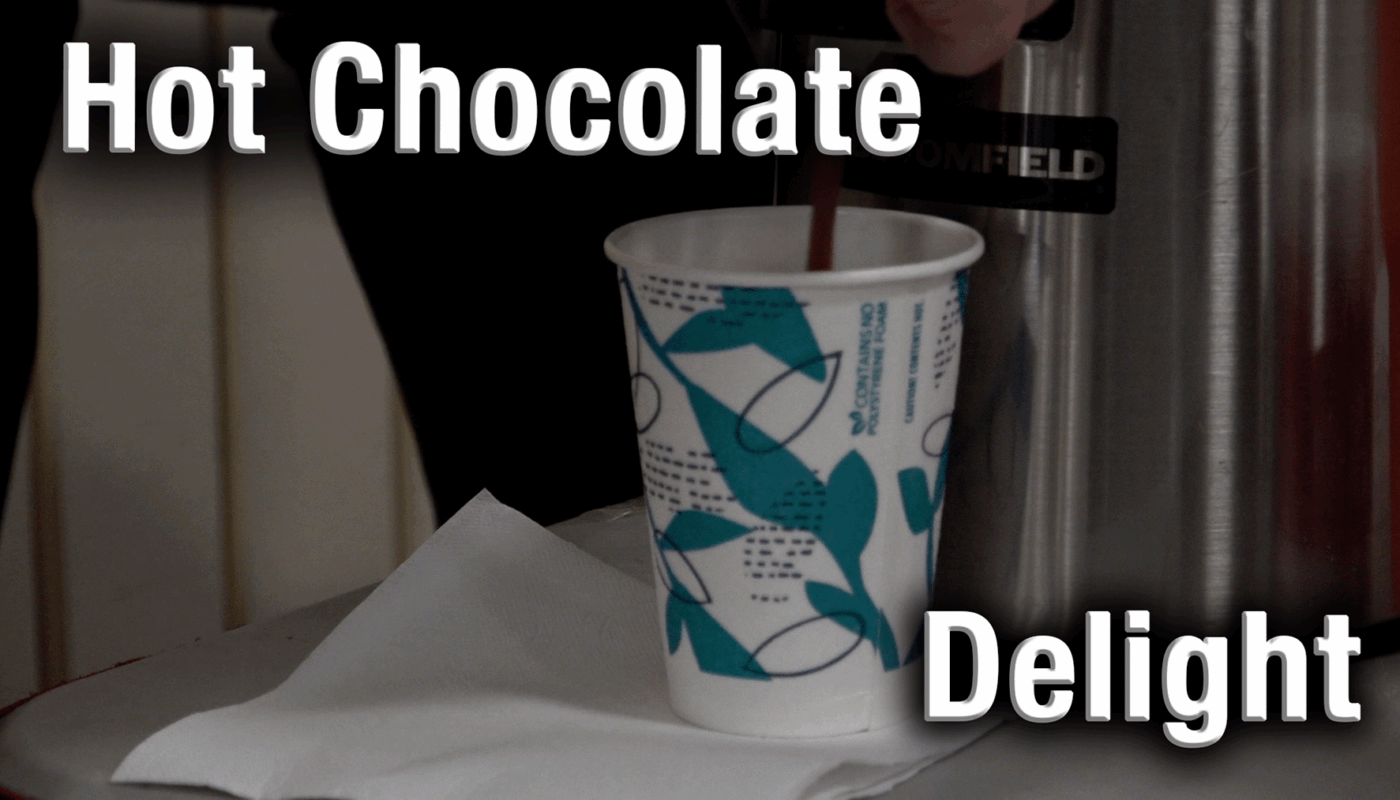 A steaming cup of hot chocolate resting on a table.