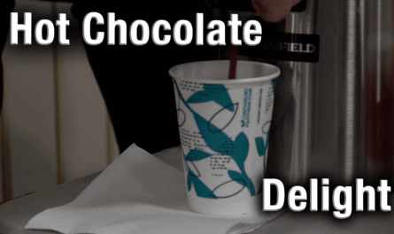 A steaming cup of hot chocolate resting on a table.