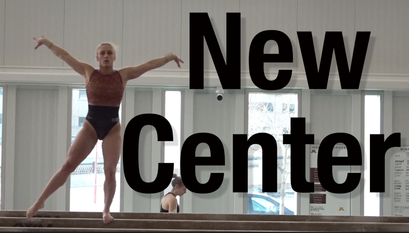 A UMN gymnast posing on a balance beam.