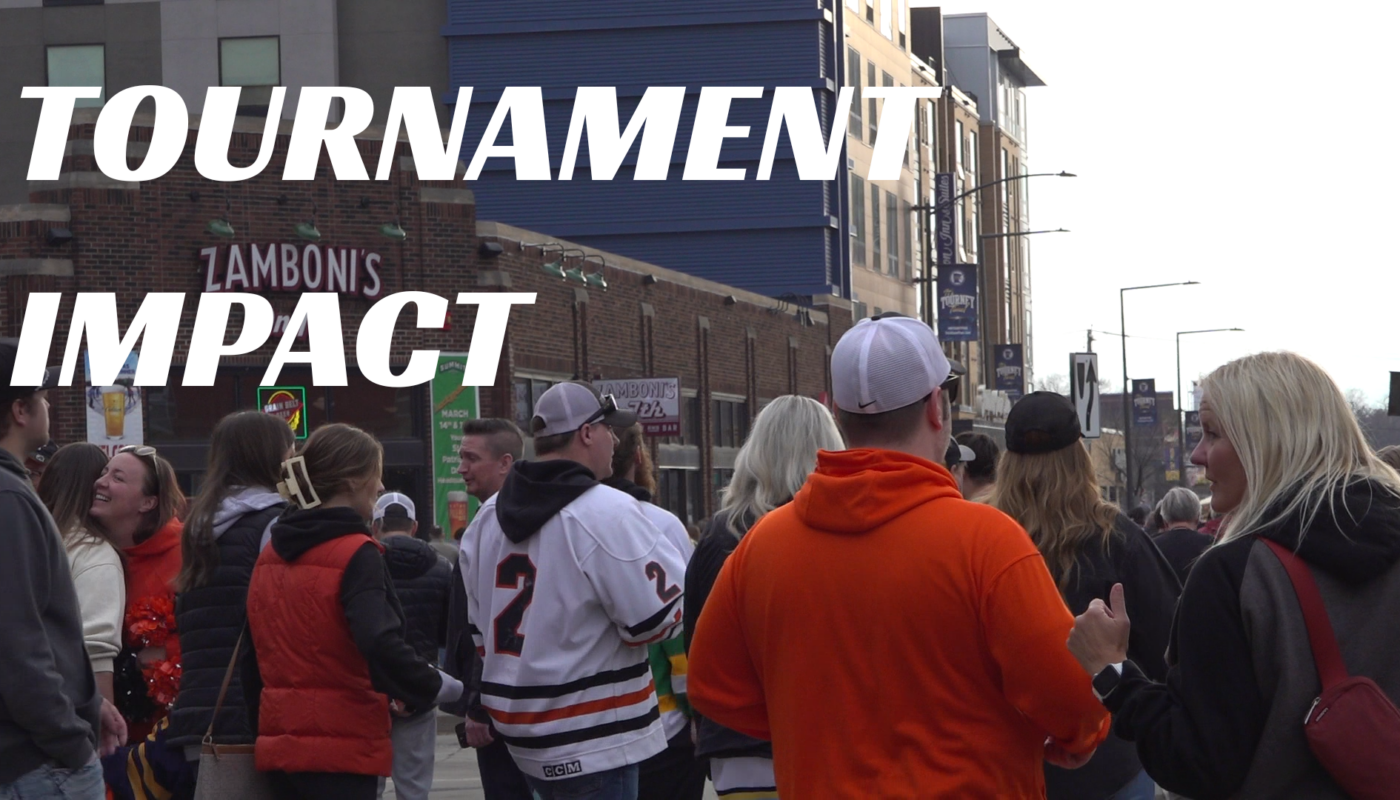 A busy sidewalk scene with hockey fans outside Grand Casino Arena in St. Paul during the Minnesota State Hockey Tournament.
