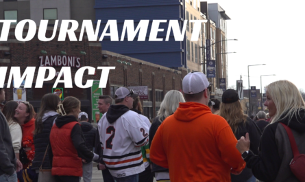 A busy sidewalk scene with hockey fans outside Grand Casino Arena in St. Paul during the Minnesota State Hockey Tournament.