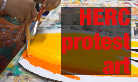 Environmental activists paint large flames as protest art against Minneapolis garbage incinerator.